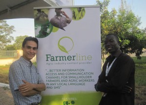 MirHossein and another gentleman standing beside a Farmerline sign.