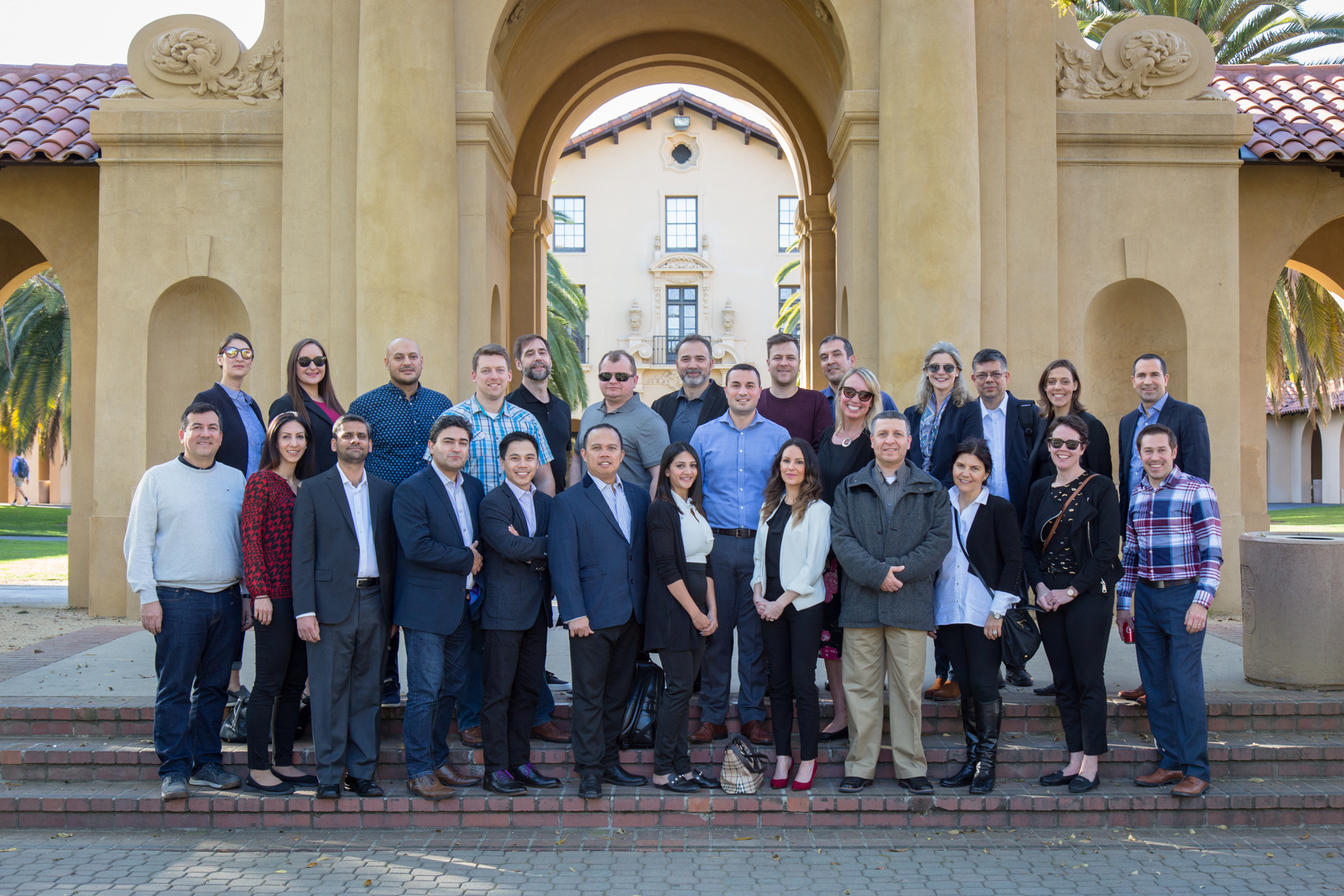 Image of EMBA candidates and DeGroote faculty and staff posing at Stanford University's Old Union.