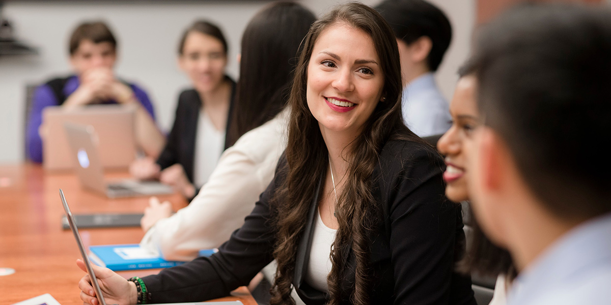 Woman Smiling at a Meeting Table