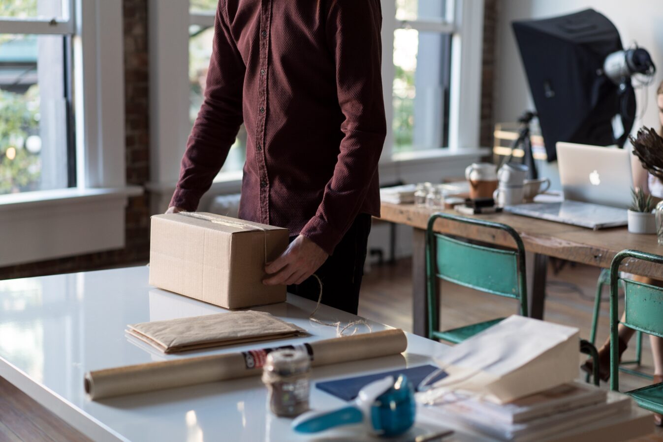 Man working at a table with a brown box