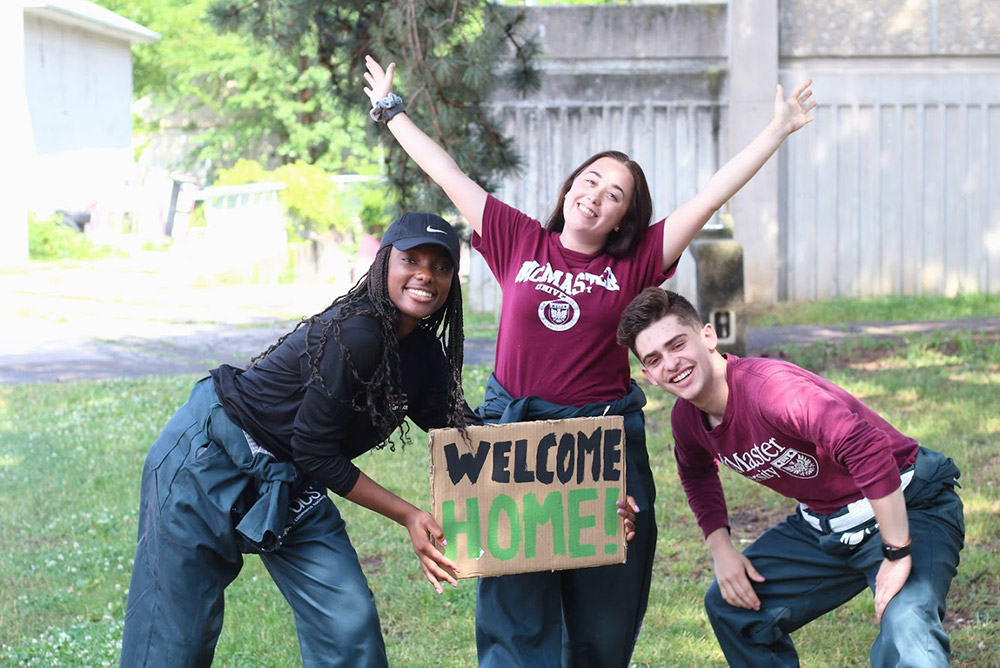 Greensuit representatives holding welcome home sign