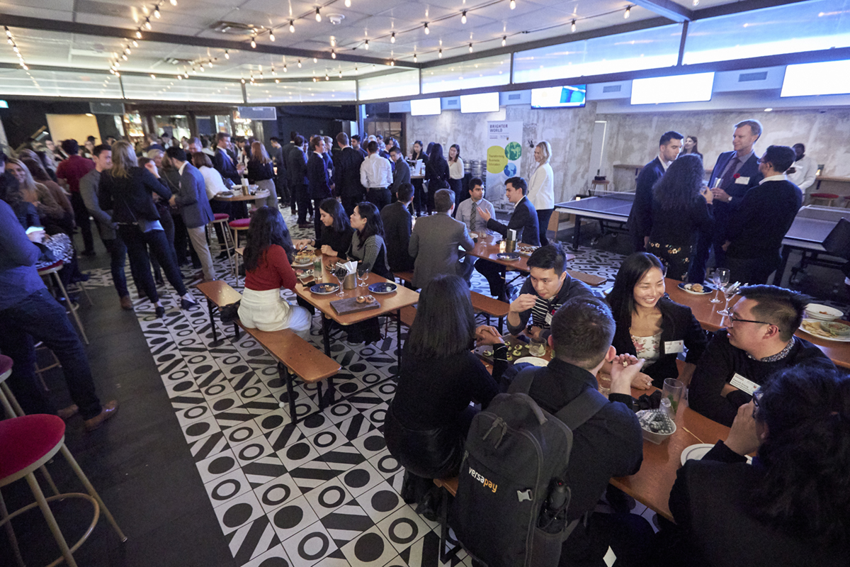 DeGroote students networking at event with food, ping pong, and cozy atmosphere