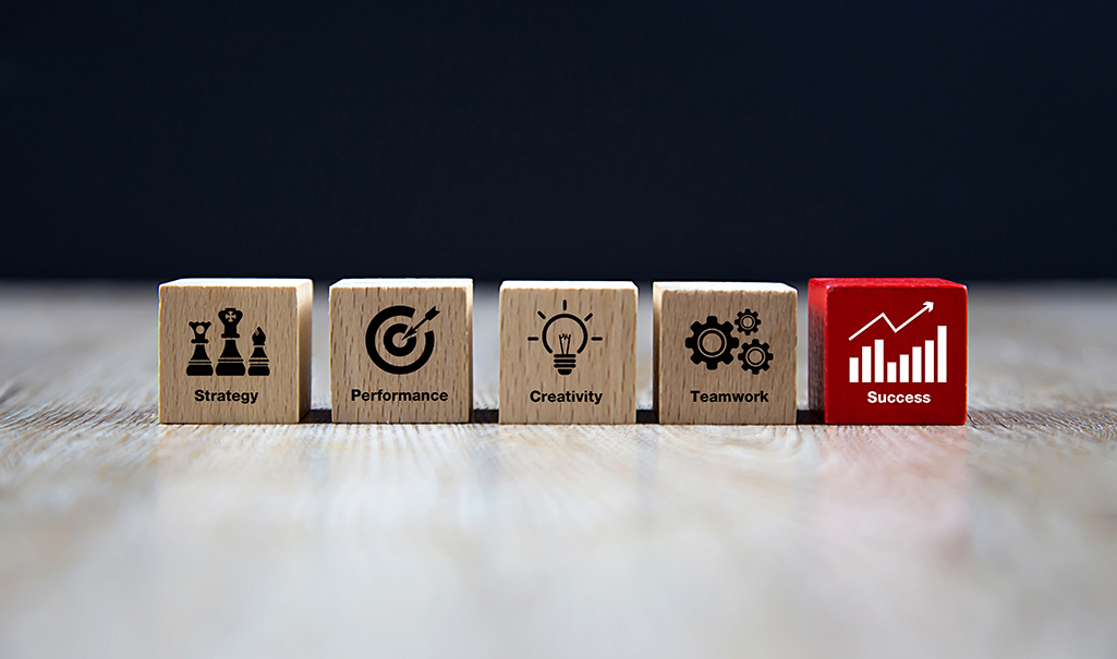 Wooden cubes with business icons for planning, strategy and success concept