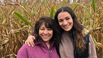 Sarah Rotella smiling with her mom in a corn field