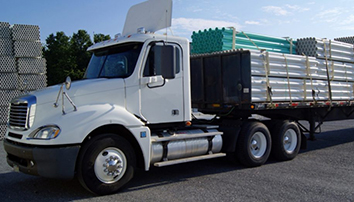 Truck carrying pipes