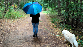 Chloe walking her dog in the forest