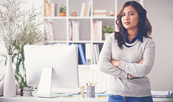 Female entrepreneur in front of desk in home office