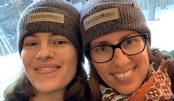Chloe with her mom wearing Hats for Hope