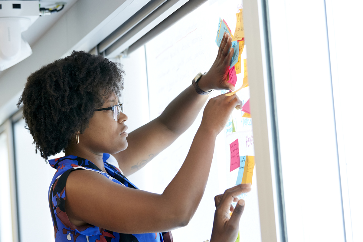 Woman posting sticky notes to window