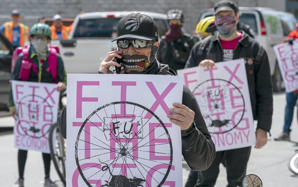 Gig economy protesters block a downtown street in Toronto, Ont. on May 1, 2020.