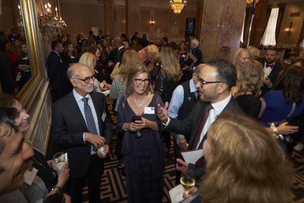 Image of Dean Khaled Hassanein talking with guests during the Accolades reception.