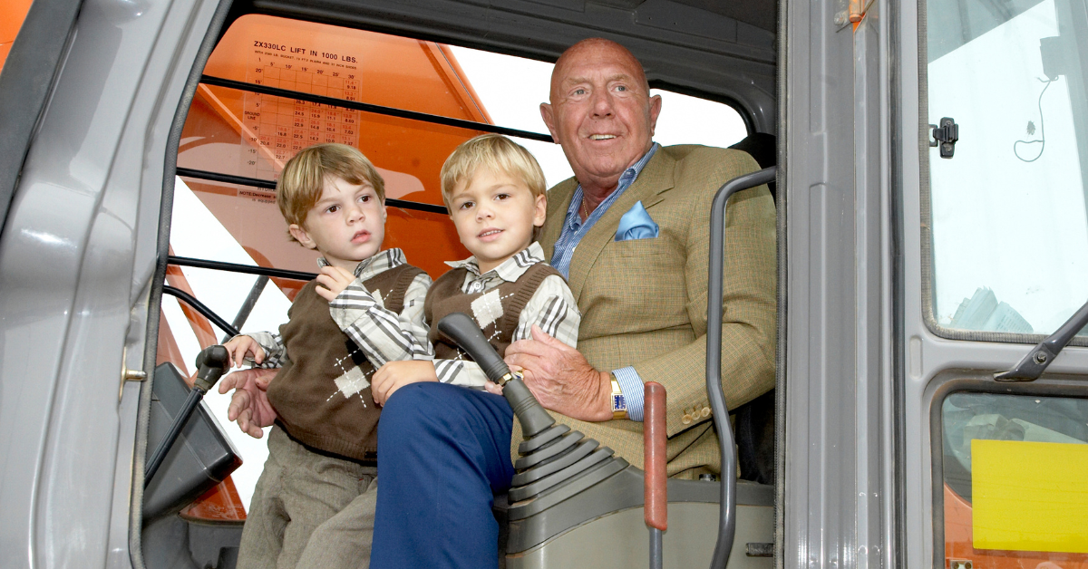 Michael G. DeGroote and family in a construction vehicle at the ground breaking for the Ron Joyce Centre Campus in Burlington in 2009