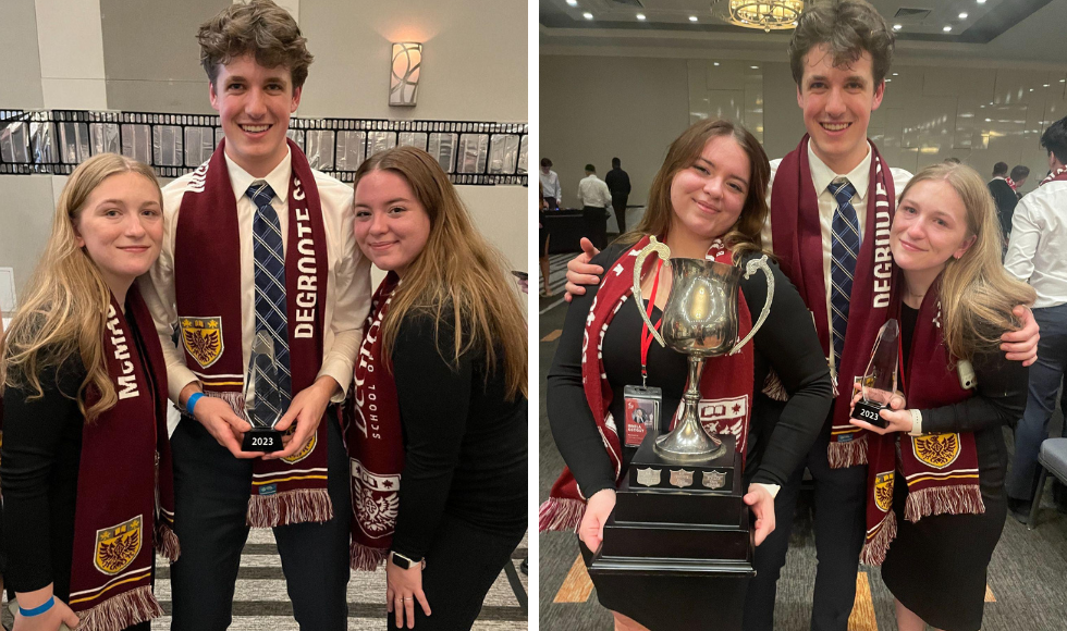 Students celebrate winning school of the year and pose with trophy.