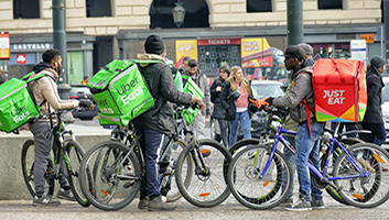 Food delivery couriers congregate in Turin, Italy. (Shutterstock)
